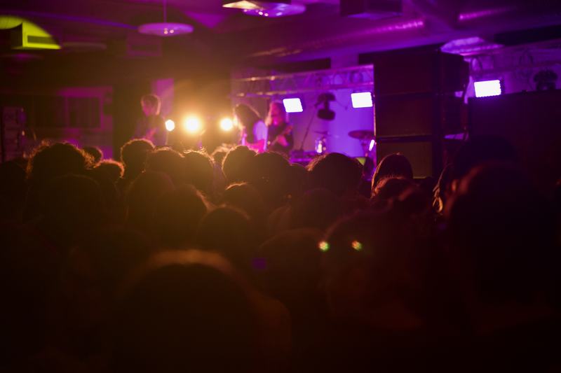 A crowd of concertgoers looks on to Wednesday performing in the background. Photo taken by Molly Shoffner for Wavelength.