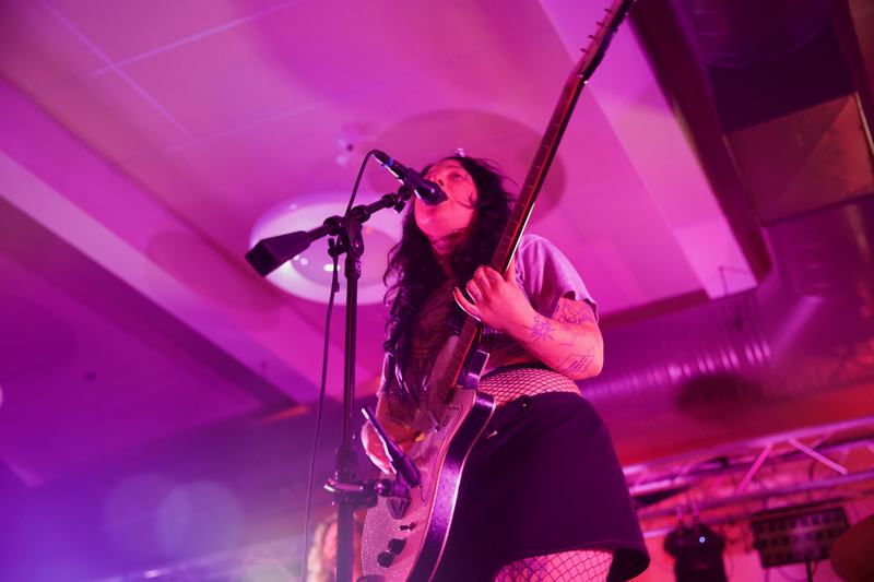 Karly Hartzman sings into the mic as she plays guitar. Photo taken by Molly Shoffner for Wavelength.