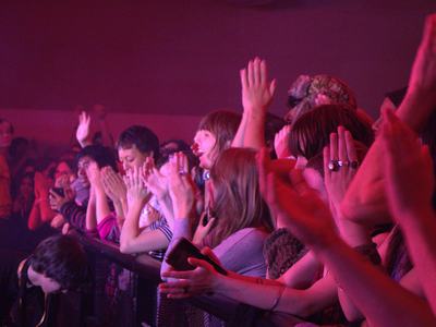 The crowd at the barricade cheering between songs
