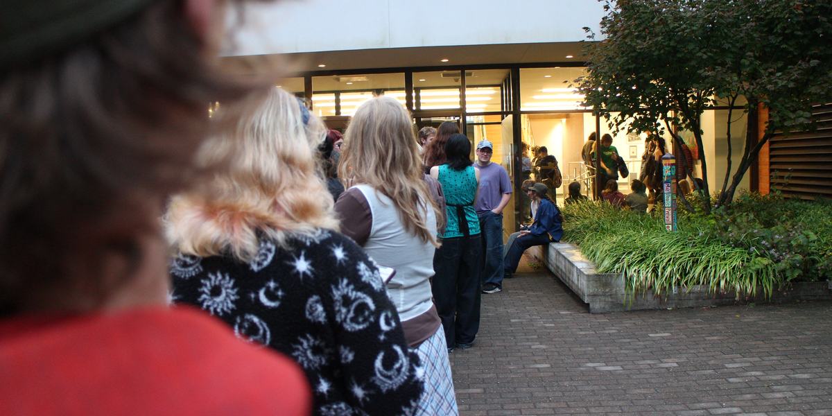Over the shoulder shot of students waiting in line before the concert