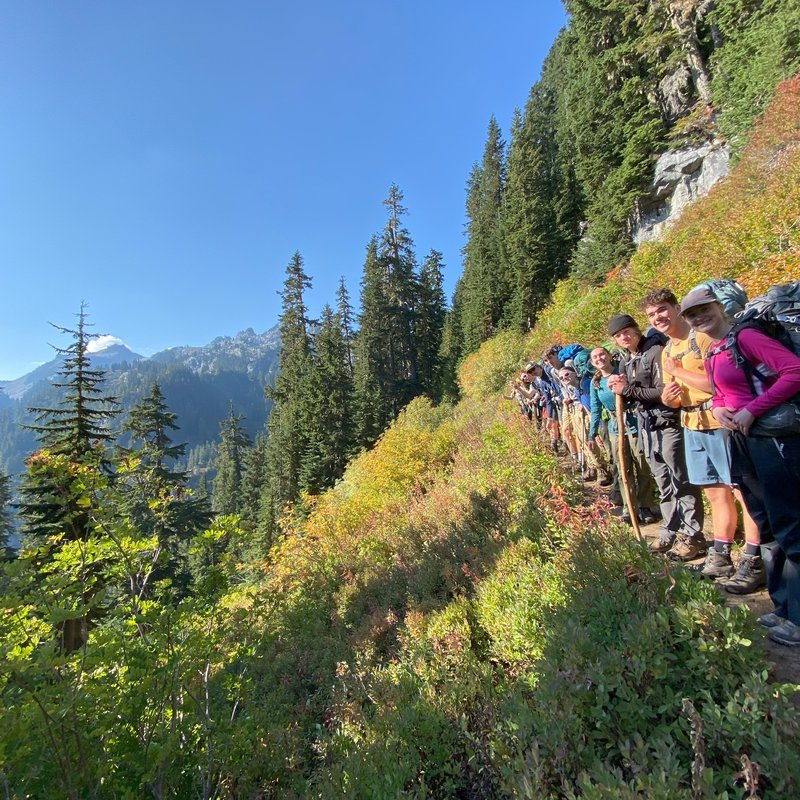 Woot group hiking in spring field