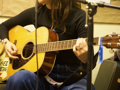 A close up of a acoustic guitar being played