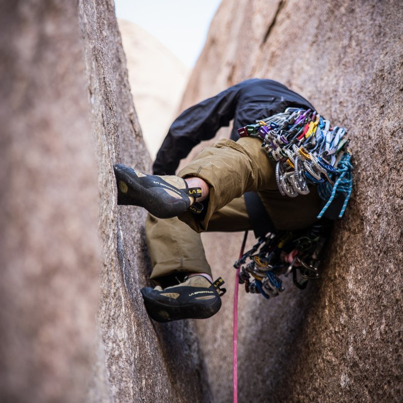 Student climbing up crevice