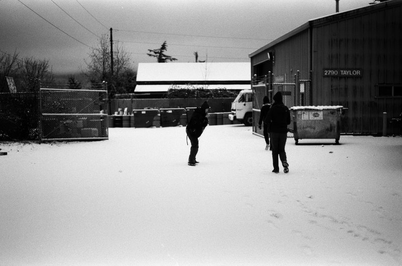 Two students stand outside the compound in the snow