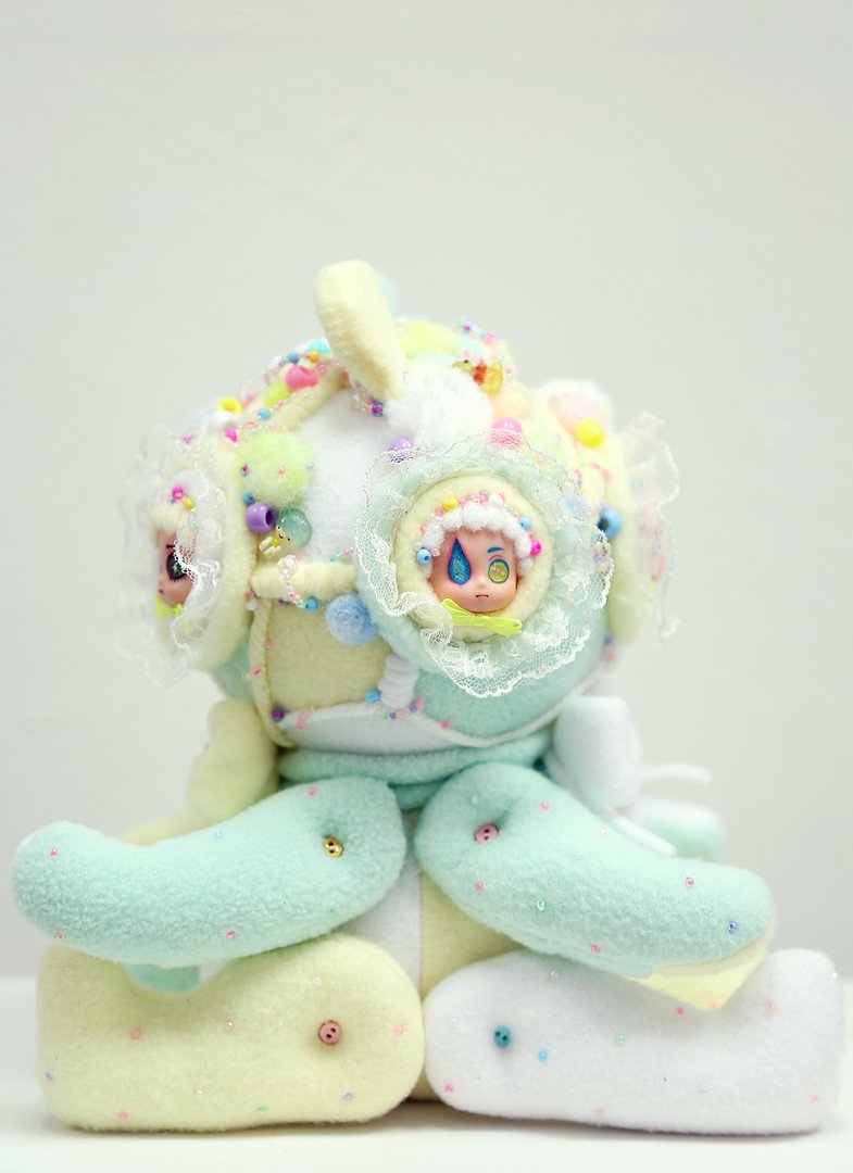 Multimedia soft sculpture in pastel tones resembling a stuffed animal side view.jpg