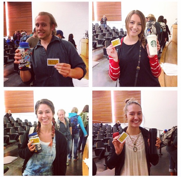 Students holding reusable cups/water bottles and punch cards for the coffee cup challenge.