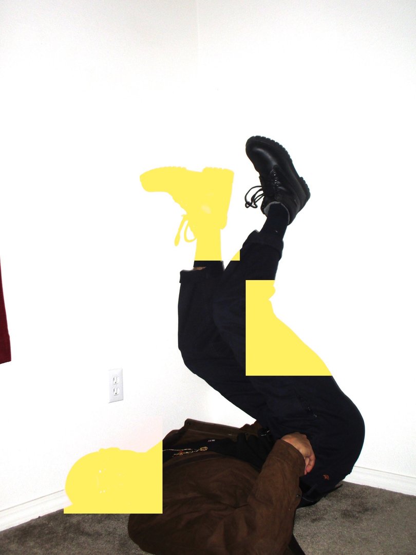 digitally edited photograph of Brandon Santana laying on his back with feet in the air, edited to block out parts of his body with the color yellow