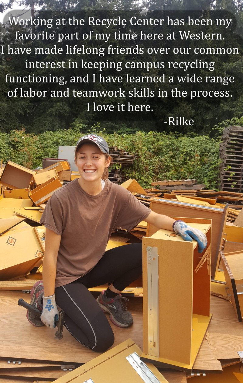 Recycle Center employee atop pile of furniture holding a hammer